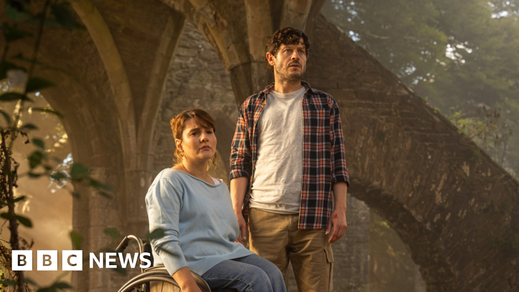 Ruth Madeley and Iwan Rheon in the new TV drama series. They both look concerned and are inside the ruins of an old building