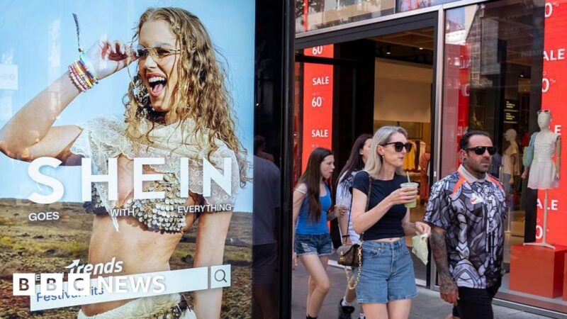 Peolep walking past a bus stop advertising for Chinese e-commerce fashion company Shein on 11 July 2026 in London
