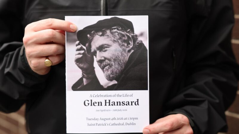 The Order of Service is held up ahead of the funeral of Glen Hansard