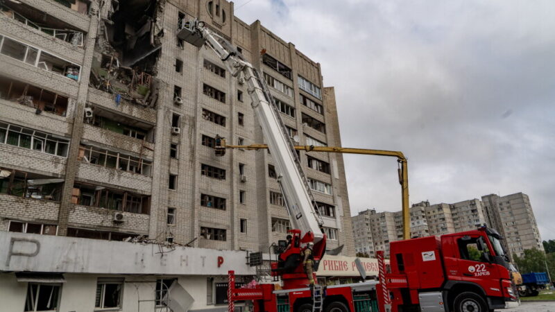 Firefighters put out a fire after a residential building was hit following Russia's drone attack in Kharkiv, Ukraine
