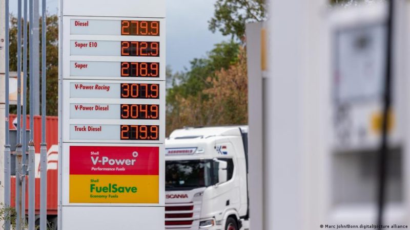 A truck seen in the background at a petrol station