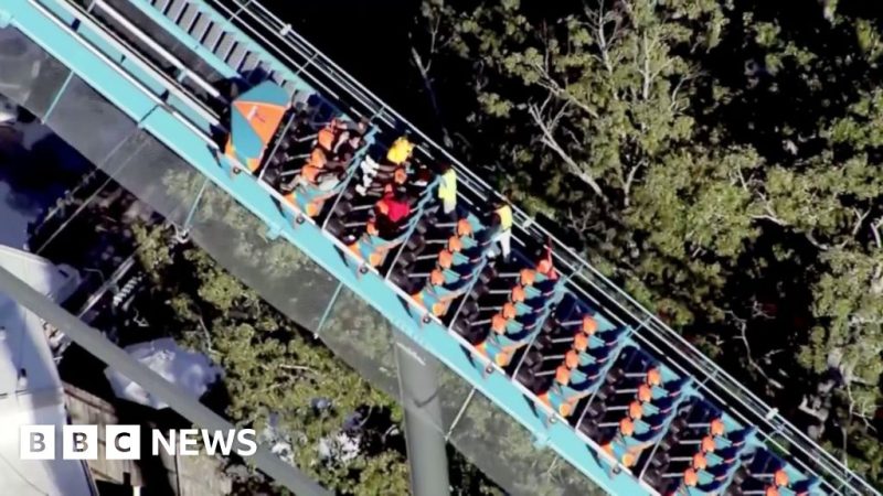 Riders are helped off a roller coaster at Six Flags in Georgia