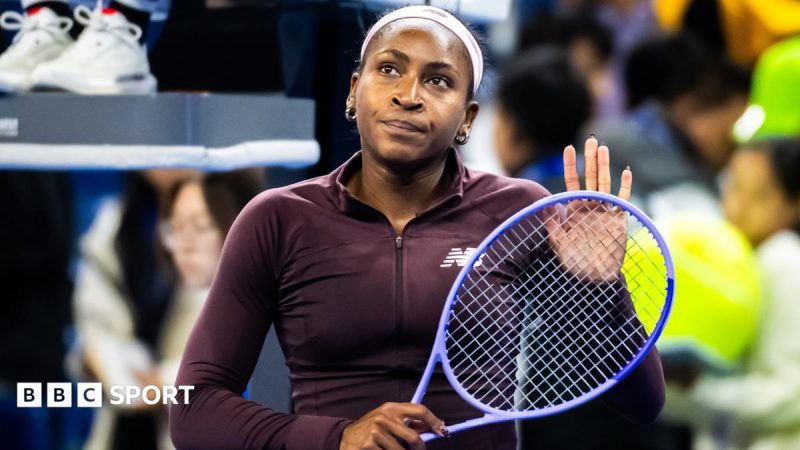 Coco Gauff pats her racket against her hand with a forlorn expression