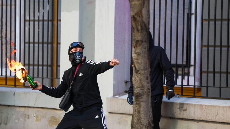 A protester throws a Molotov cocktail, during an anti-government protest by students in Tirana, Albania, October 18, 2026