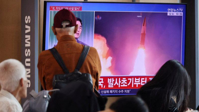 People watch a TV broadcasting a news report on North Korea firing multiple ballistic missiles toward the sea off its east