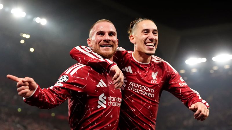 Alexis Mac Allister celebrates scoring Liverpool's third goal with team-mate Kostas Tsimikas (right). Photograph: Nick