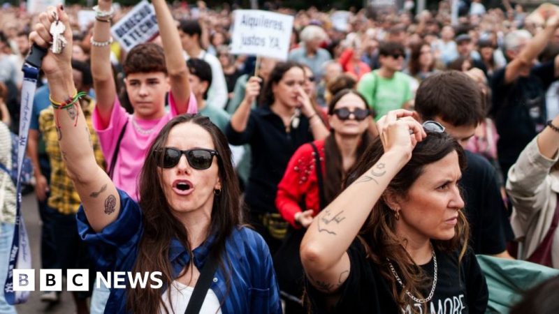 Protesters march through Madrid, with two women in front