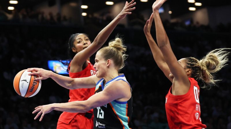 New York Liberty forward Leonie Fiebich, center, passes the ball against Atlanta Dream forwards Angel Reese, left, and Naz