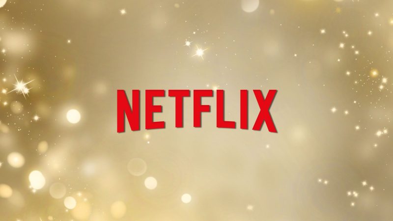 Netflix logo on a gold sparks background